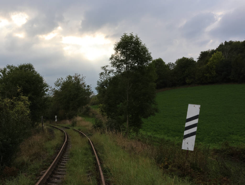 Sun almost setting above an abandoned railway.