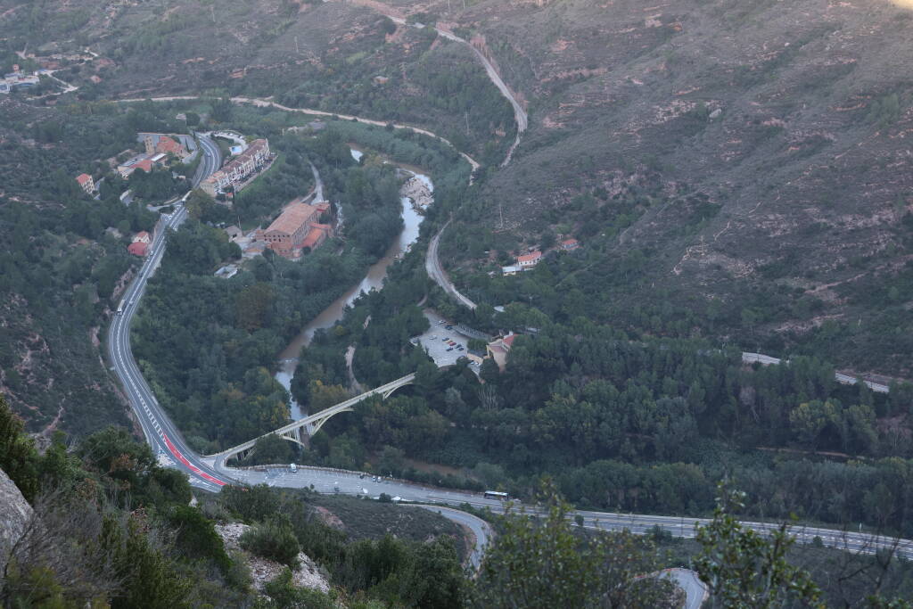 Far below me, you can see a road, a railroad and a valley station of a cable car.