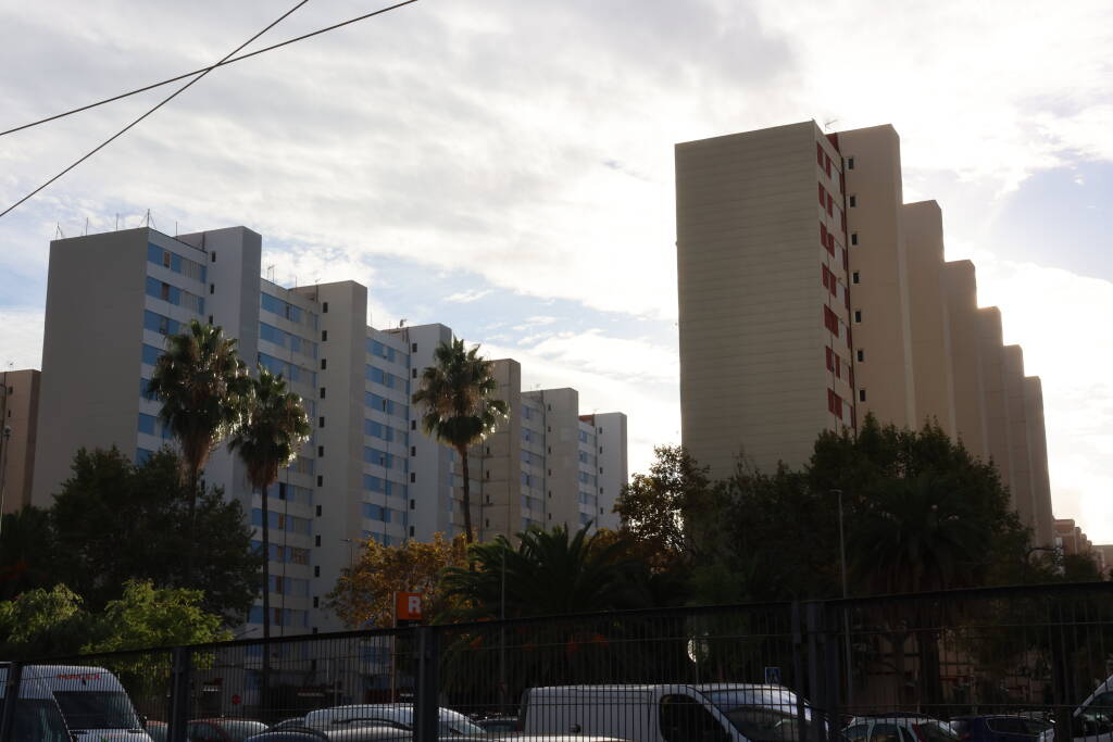 Colorful plattenbau houses, reminding me of Prague. Why is there a fence on the roof though?