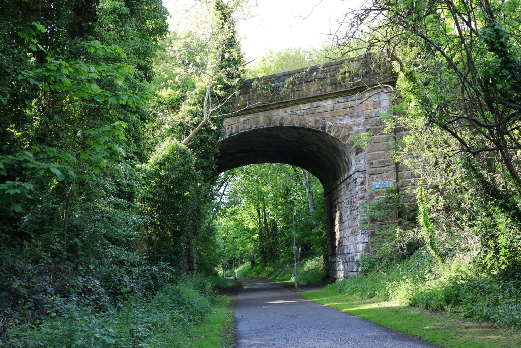 The railway (path, actually) is mostly under the level of nearby streets which are on bridges above.