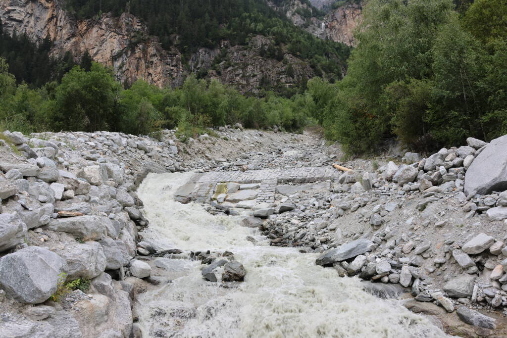 A creek but not an ordinary one. Just in the middle of the photo, there is the a tunnel roof.