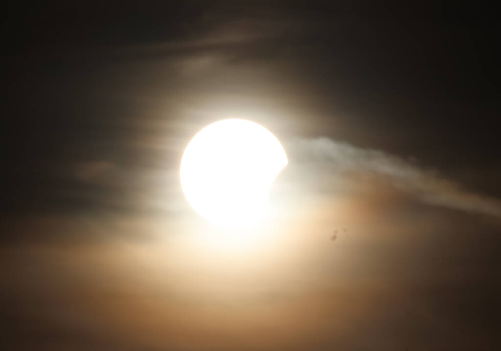 The sun is dipping behind a cloud.